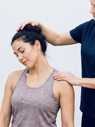 A TRUForm provider performing a gentle neck assessment on a patient at Texas Functional Health Centers in Dallas, TX